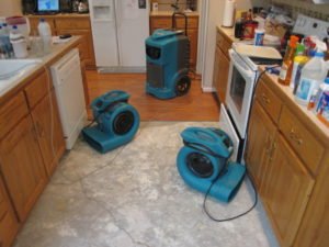 water damage photo of two air movers and one stand up dehumidifier; the water removal drying process