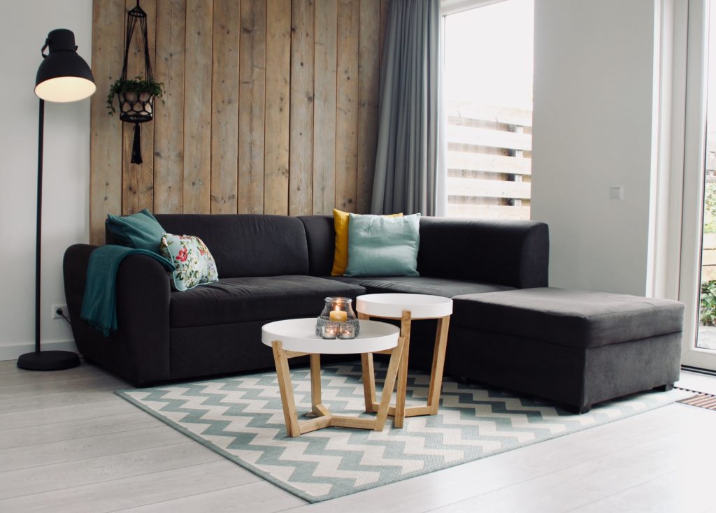 A living room with a burning candle to remove odors from the home.